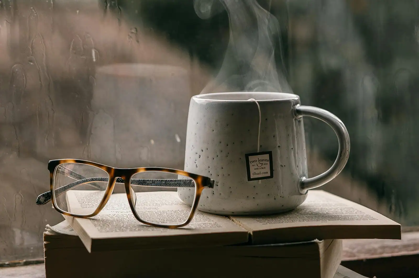 Cozy cup of tea next to a rainy window