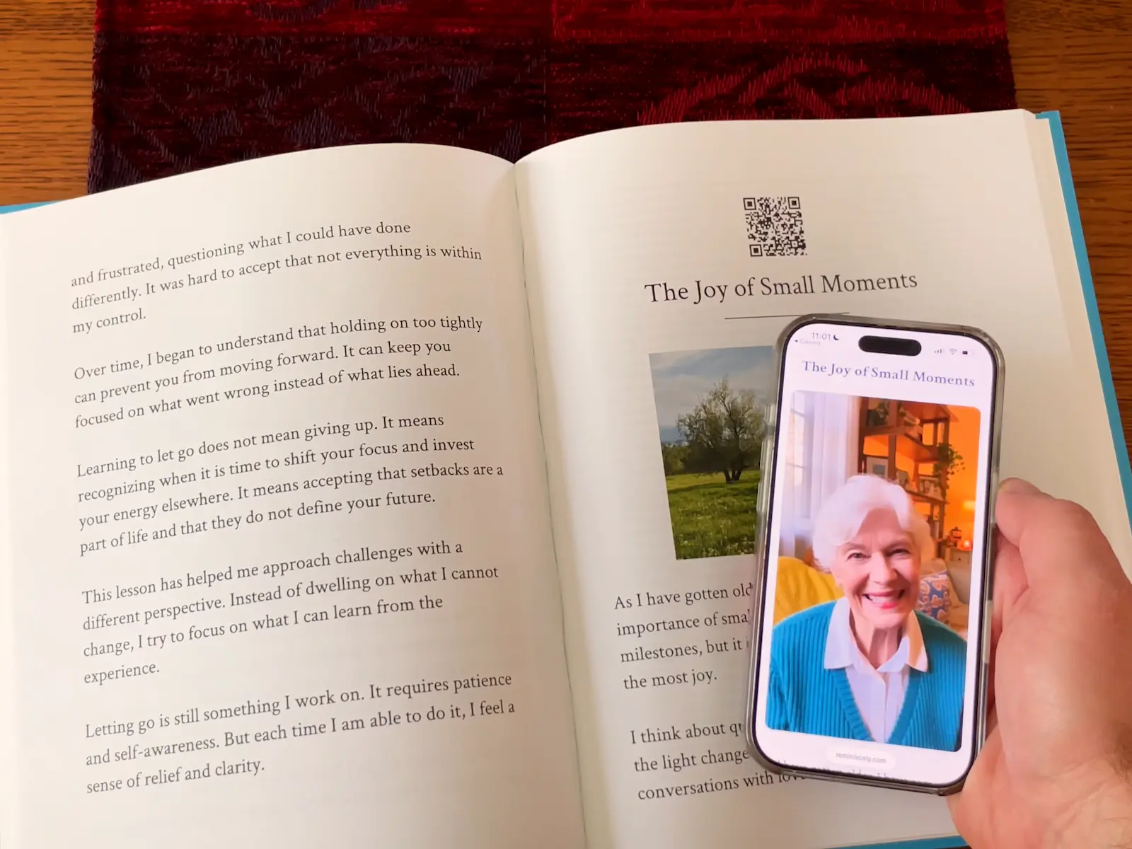 Reminiscely hardcover book with QR code being scanned