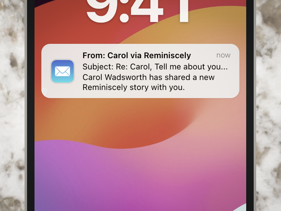 A phone display a Reminiscely email notification